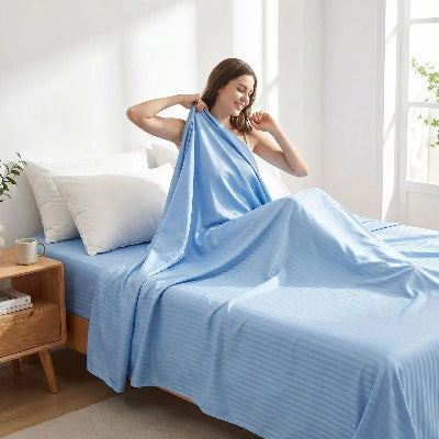 femme souriante sur drap plat coton 600 fils