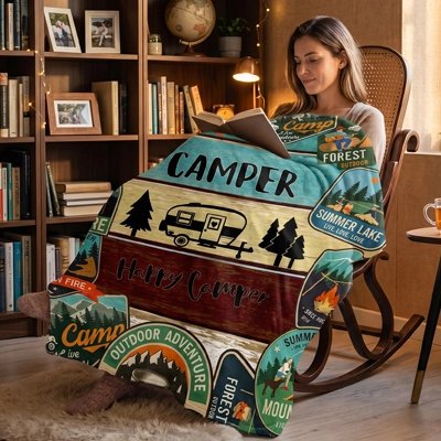  femme enveloppée dans couverture turquoise et bordeaux lit livre