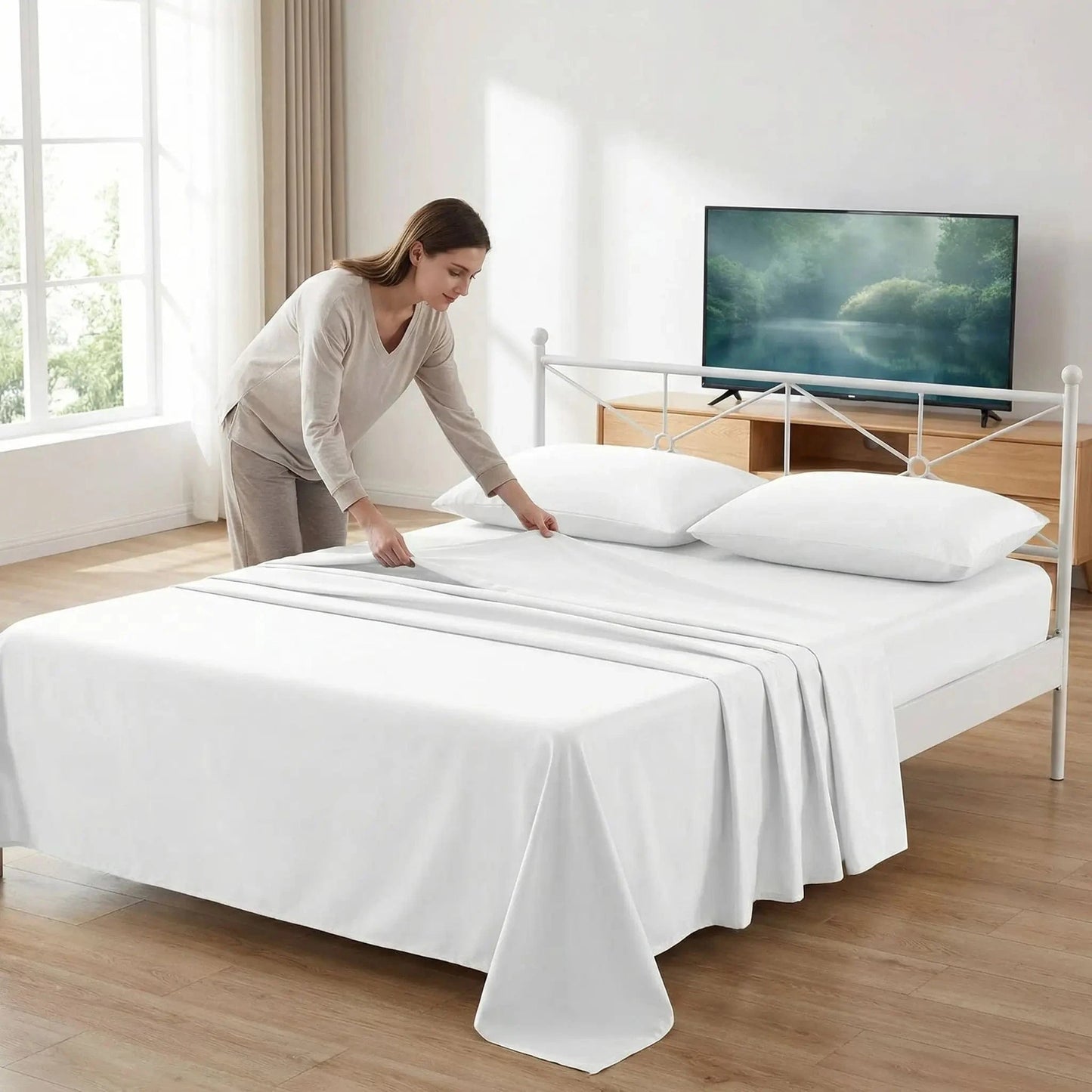 femme plie son drap plat blanc côté télévision