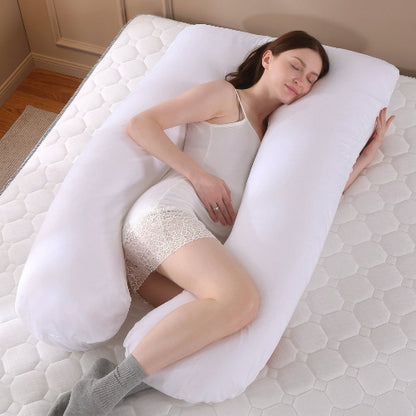 jeune femme enceinte endormie sur traversin haut de gamme blanc