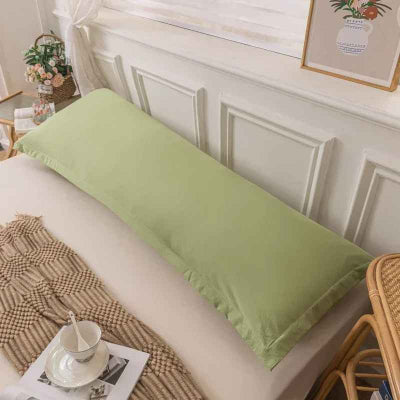 taie traversin verte sur lit dans chambre